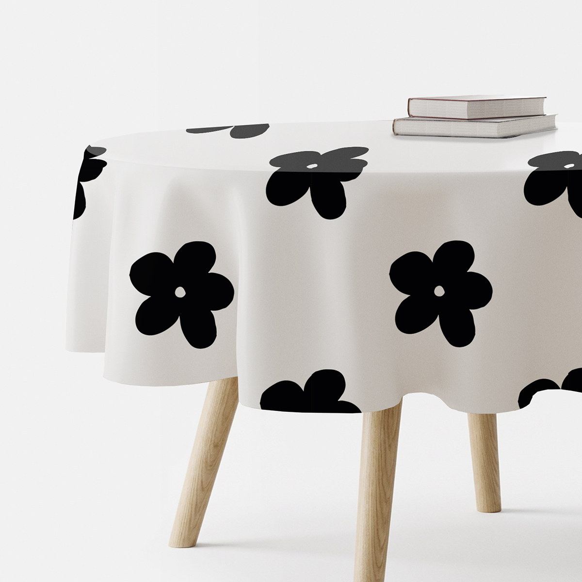 okrągły obrus na stole z dużymi czarnymi graficznymi kwiatami, główne ujęcie
