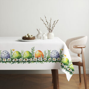 aranżacja stołu z minimalistycznymi dekoracjami i obrus z motywem pisanek
