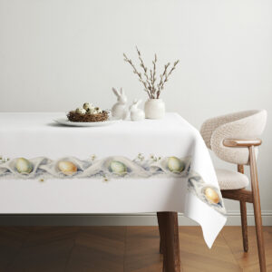 aranżacja stołu ze świątecznym obrusem, koszyk z jajkami i gałązki bazie