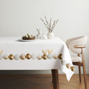 aranżacja stołu z obrusem, koszyk z pisankami i subtelna wiosenna dekoracja