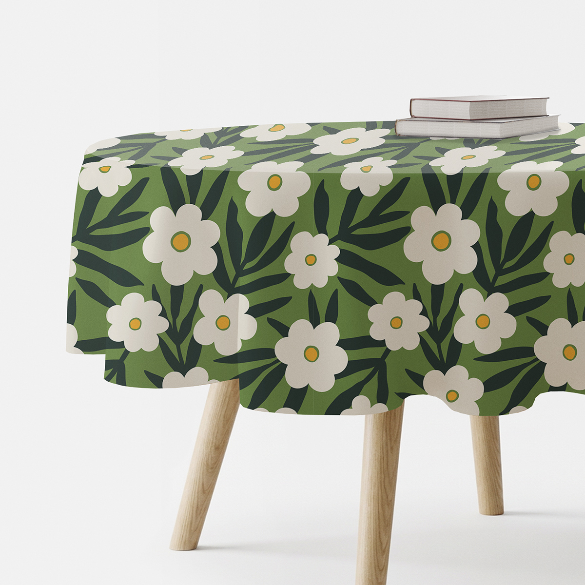 Obrus okrągły rozłożony na stole z wzorem białych kwiatów na zielonym tle, ujęcie główne