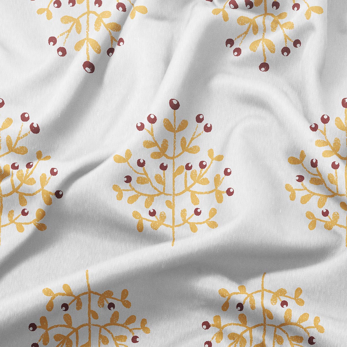 Zbliżenie na nadruk gałązek w ciepłym żółtym i bordowym kolorze, widoczna faktura tkaniny