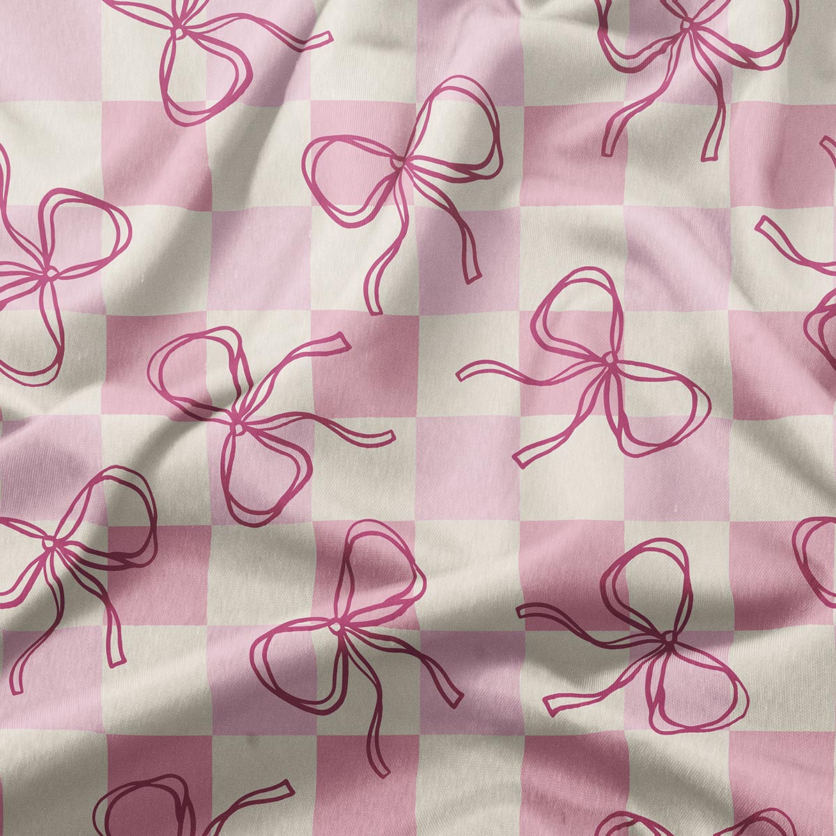 zbliżenie tkaniny pokazujące rysowane kokardki na delikatnej kratce