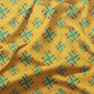 zbliżenie tkaniny pokazujące turkusowe kwiaty i czerwone akcenty na żółtym tle