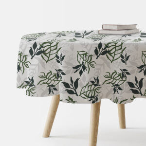 okrągły obrus na stoliku z motywem zielonych liści i dwoma książkami na brzegu stołu