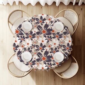 widok z góry na okrągły stół z obrusem, równomiernie rozmieszczony wzór kwiatów na beżowym tle