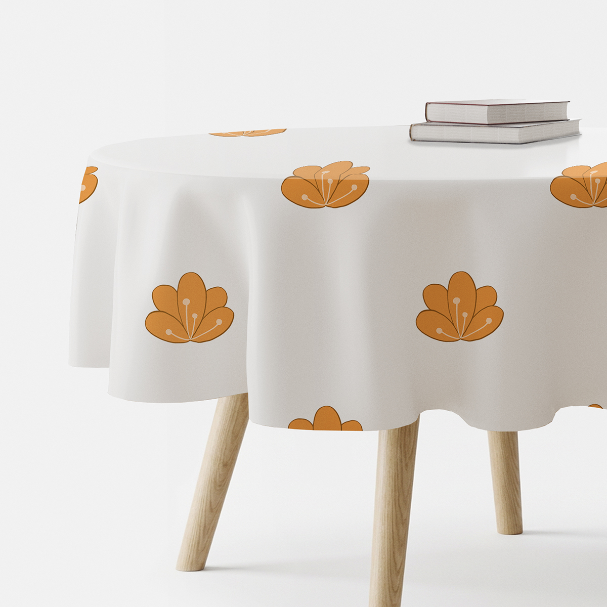 okrągły obrus na stole z powtarzalnym motywem stylizowanych pomarańczowych kwiatów, ujęcie boczne