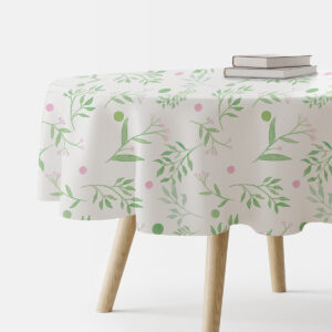 okrągły obrus na stole z akwarelowym wzorem zielonych gałązek i różowych kropek