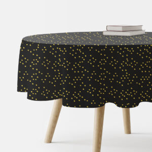 okrągły czarny obrus z drobnymi złotymi kropkami na stole