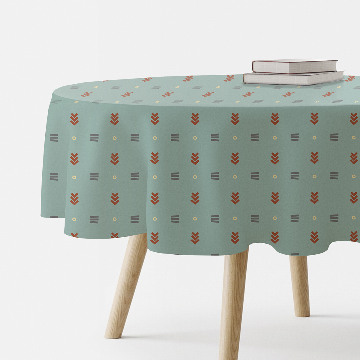 Okrągły obrus w miętowym kolorze z regularnym geometrycznym wzorem na drewnianym stole