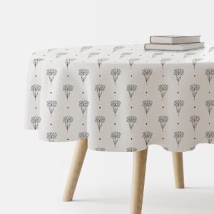 okrągły obrus z białym tłem i cienkim, szkicowym wzorem kwiatowym na stole