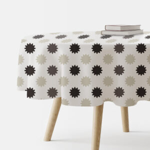 okrągły obrus z neutralnym wzorem rozbłysków ułożony na stoliku z książkami