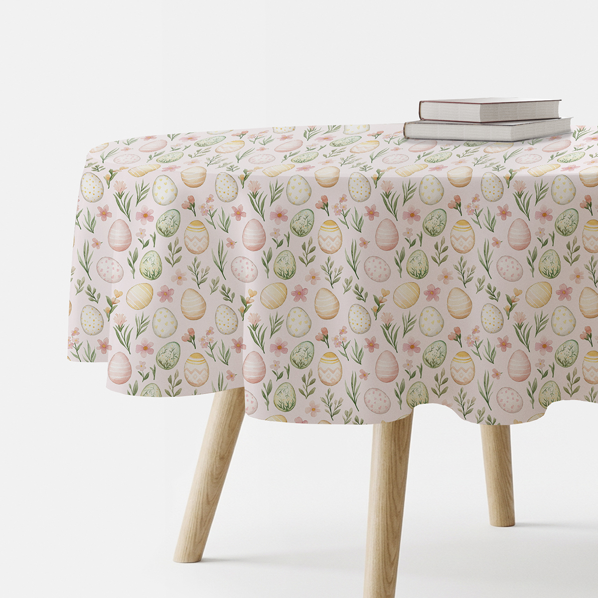 okrągły obrus z motywem akwarelowych pisanek i wiosennych gałązek na stole