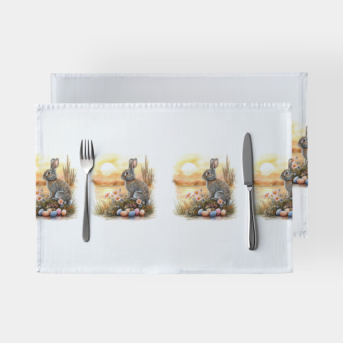 Podkładki na stół z motywem zajączka i pisankami, widok z góry z sztućcami