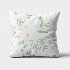 biała poduszka z akwarelowymi zielonymi gałązkami i różowymi kropkami na jasnym tle