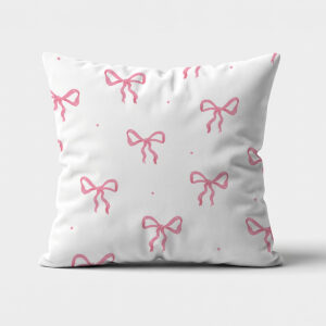 Główne ujęcie białej poduszki z powtarzalnymi różowymi kokardkami na jasnym tle