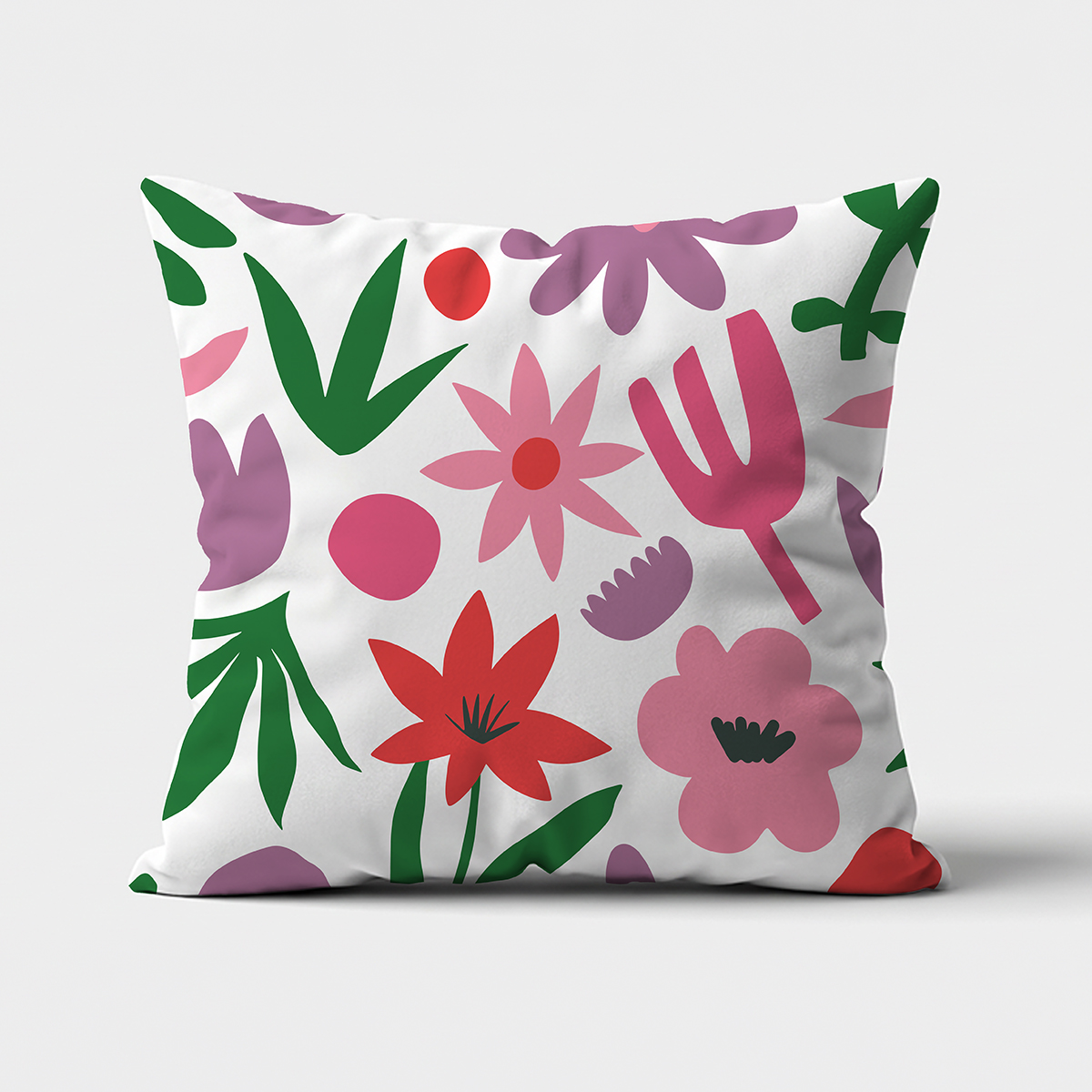Poduszka z kolorowym, uproszczonym motywem kwiatowym na białym tle, widok z przodu