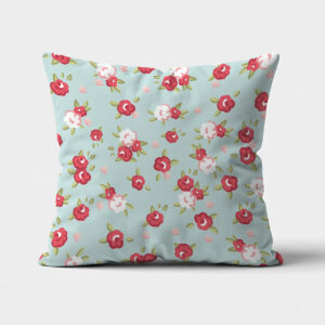 Poduszka dekoracyjna z miętowym tłem i drobnymi czerwonymi oraz białymi różyczkami, widok z przodu