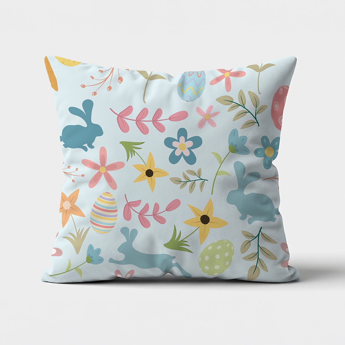 Główne ujęcie poduszki z pastelowym wzorem z zajączkami, pisankami i kwiatami na jasnym tle