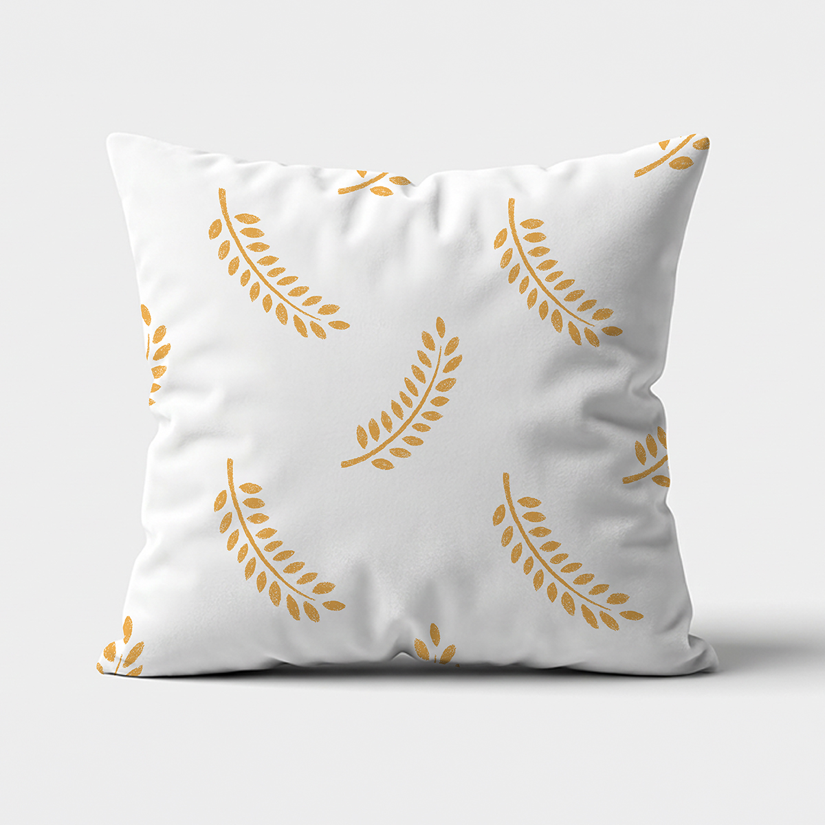 główne ujęcie białej poduszki z powtarzającym się złotym motywem gałązek