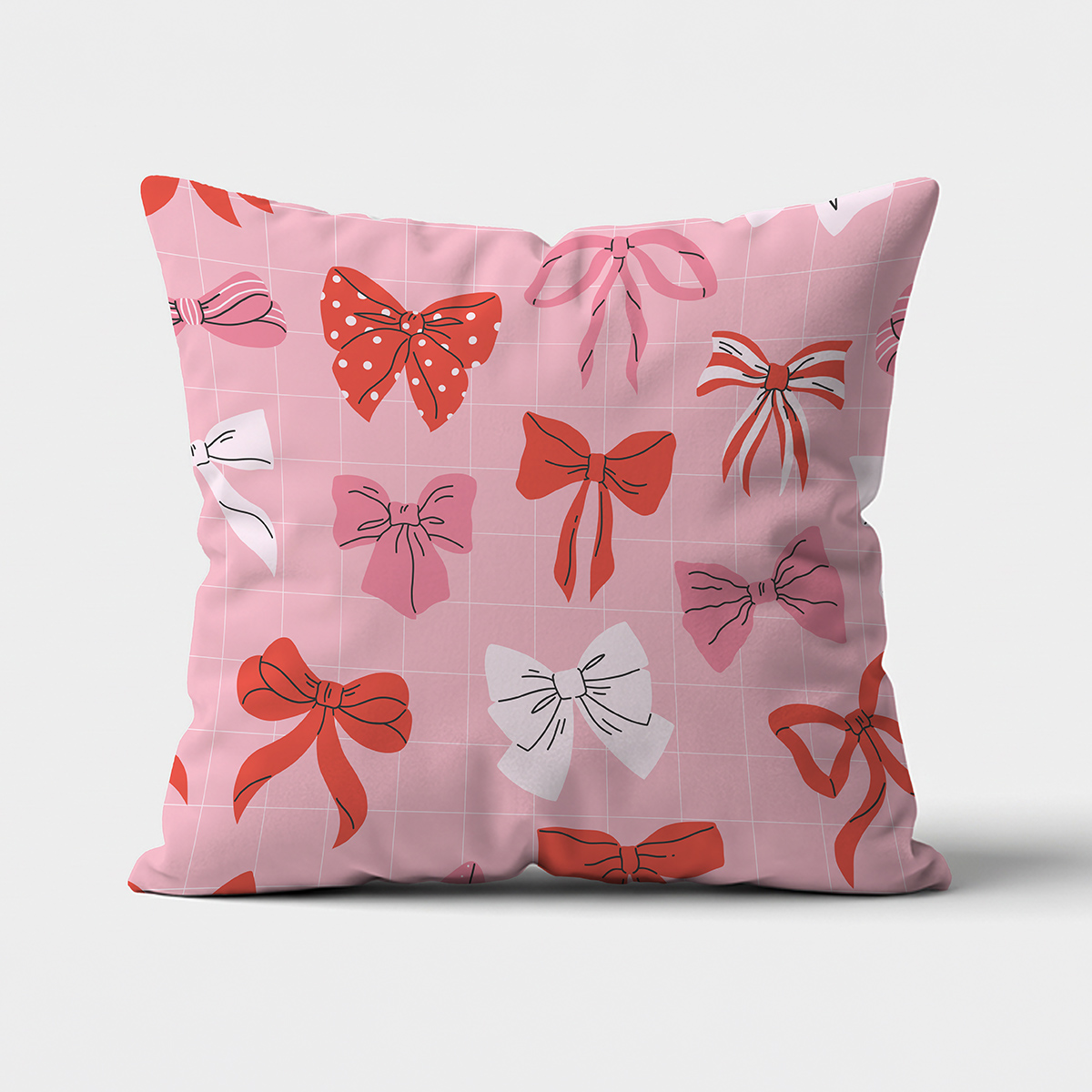 Poduszka dekoracyjna z różowym tłem i wzorem kokardek, widok z przodu