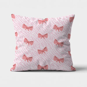 frontowe ujęcie poduszki ozdobnej z różowymi kokardkami na delikatnym tle