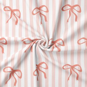 detal tkaniny z powtarzalnym wzorem kokard na jasnych pionowych pasach