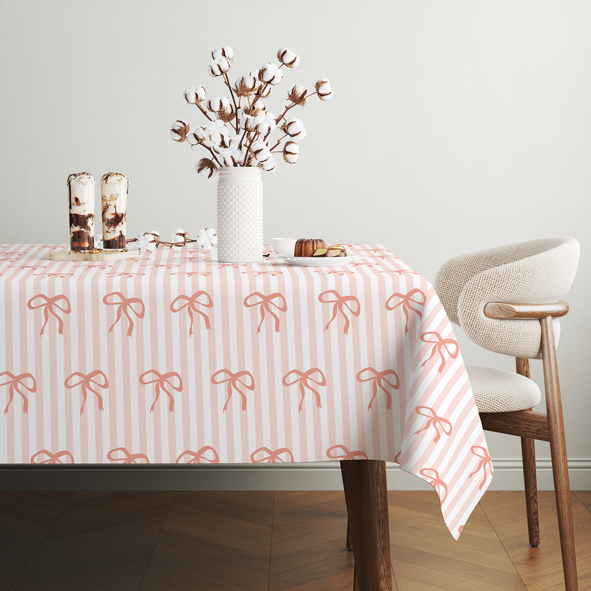 widok stołu w jasnym wnętrzu z dekoracją i obrusie w delikatny wzór kokard