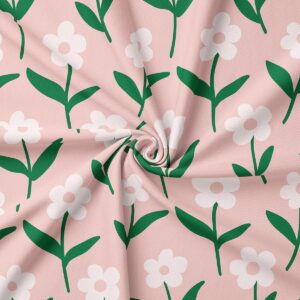 zbliżenie na teksturę tkaniny i wzór białych stokrotek na różowym tle