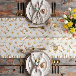 Świąteczna aranżacja stołu z bieżnikiem, talerzami i wiosennymi dekoracjami