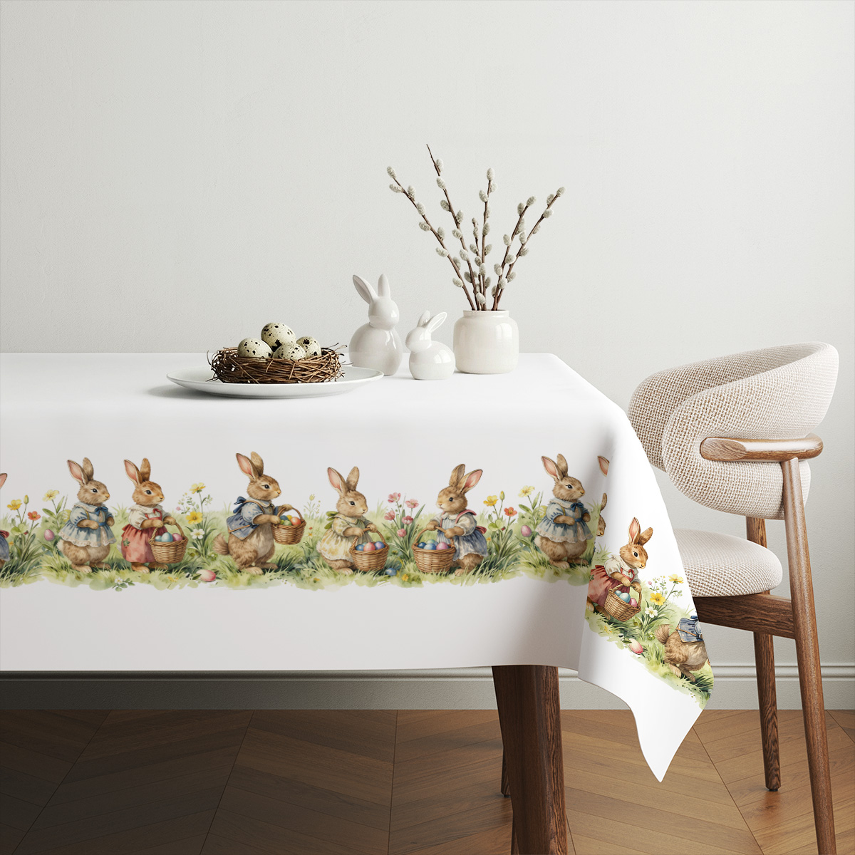 Aranżacja stołu ze świątecznymi dekoracjami i obrusem z motywem uroczych króliczków