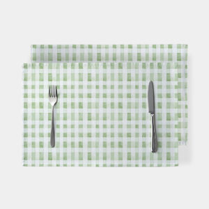 miętowo-białe podkładki w akwarelową kratkę ułożone jedna na drugiej z widelcem i nożem