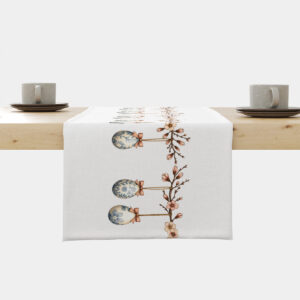 Bieżnik rozłożony na stole z motywem gałązek i wiszących pisanek widok z góry