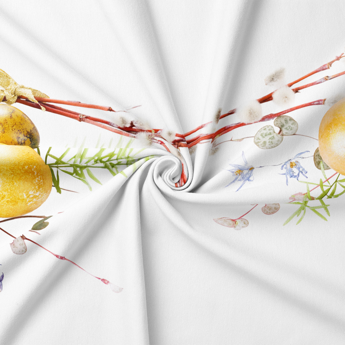 zbliżenie na drukowane pisanki i delikatne gałązki na tkaninie