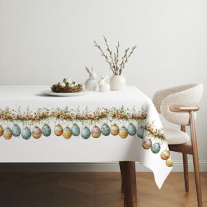 aranżacja stołu z obrusie, koszyk z jajkami i gałązki jako świąteczna stylizacja