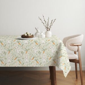 Aranżacja stołu z obrus świąteczny wielkanocny, ozdobiony dekoracjami i gałązkami bazi