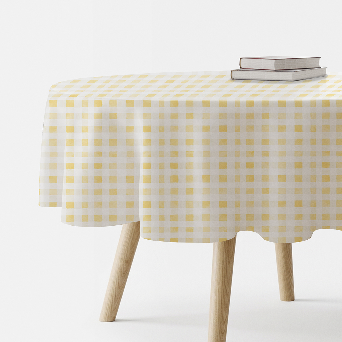 okrągły obrus na stole z żółto-białą drobną kratką