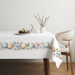 aranżacja stołu z obrusem, koszykiem z jajkami i gałązkami jako świąteczna dekoracja