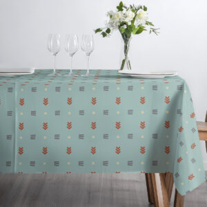 Ujęcie stołu z trzema kieliszkami i talerzami na miętowym obrusie z geometrycznym motywem