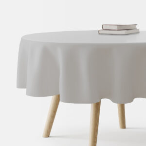 okrągły stół przykryty jasnoszarym obrusem widok z boku z książkami na blacie