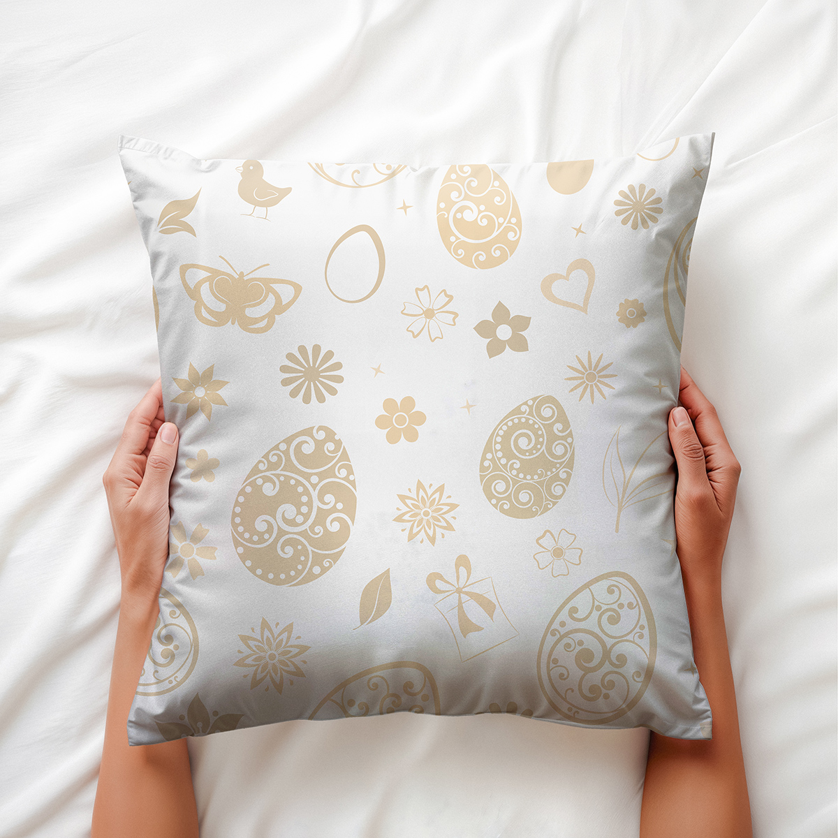 Ręce trzymające poduszkę z delikatnym wzorem kremowych jajek i kwiatów