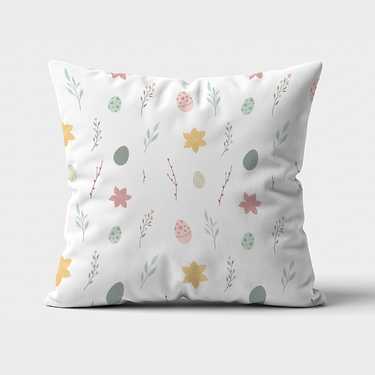 Poduszka z białym tłem i drobnym wzorem pisanek oraz liści na głównym ujęciu