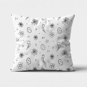 Poduszka widok z przodu z czarnym, rysunkowym wzorem jajek i kwiatów na białym tle