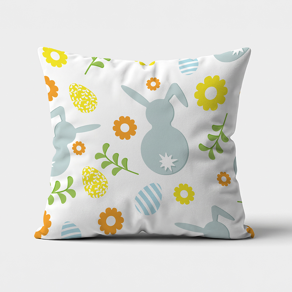 Poduszka z nadrukiem zajączków i kolorowych pisanek na jasnym tle, ujęcie frontalne