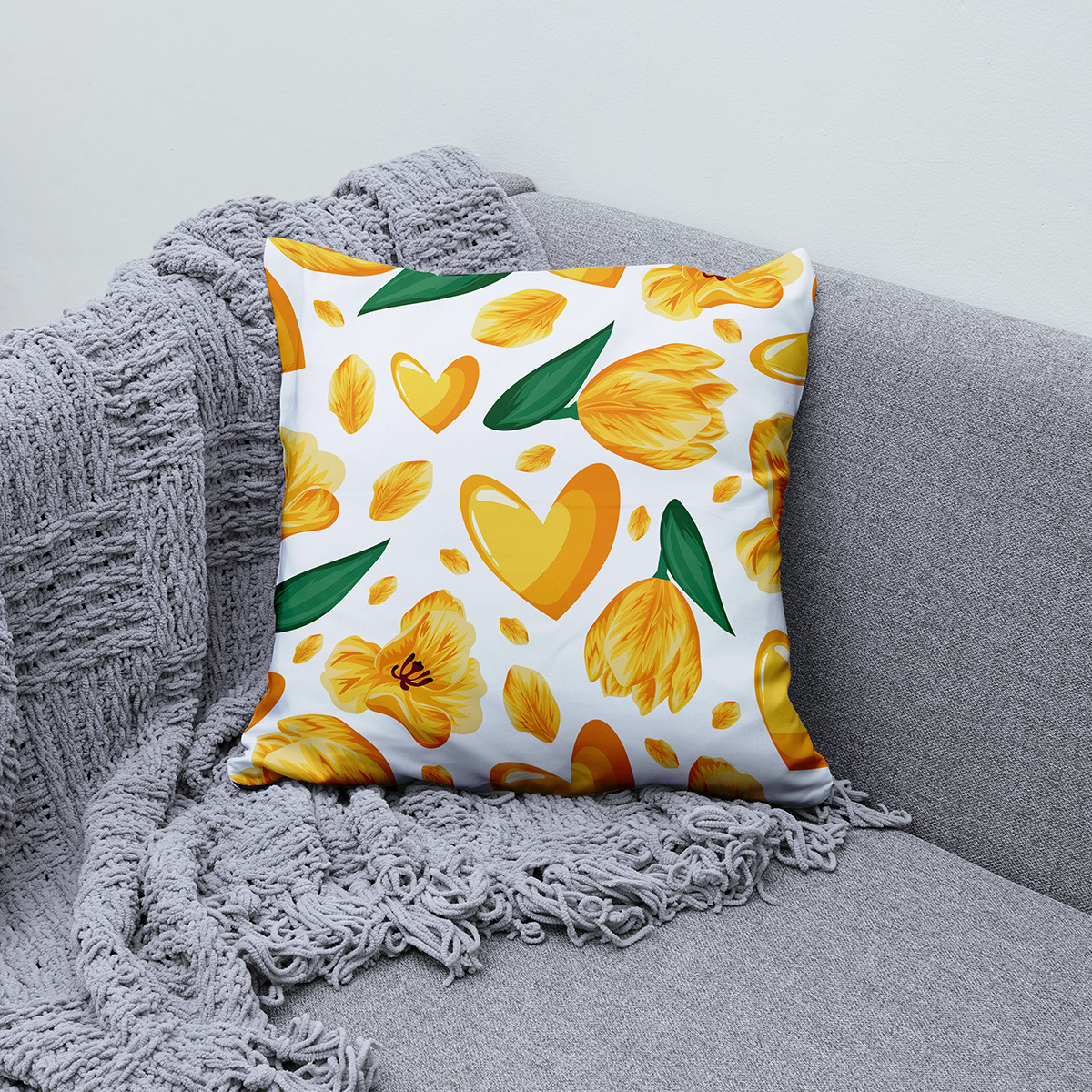 Poduszka z żółtym motywem ustawiona na sofie jako dekoracja wnętrza