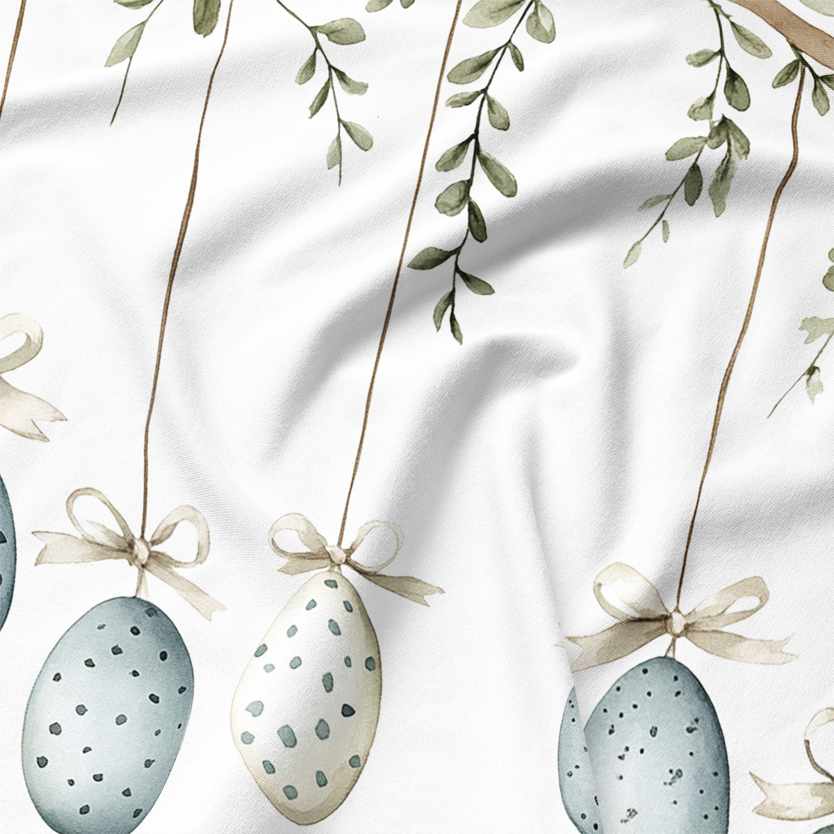 Zbliżenie detalu: akwarelowe jajka ze wstążkami i liśćmi na tkaninie