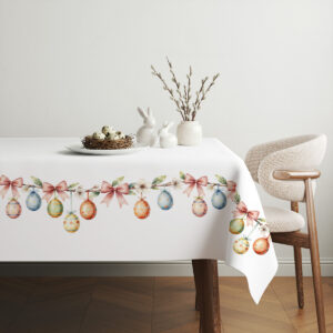 aranżacja stołu z świątecznym obrusem, dekoracjami i wiosennymi dodatkami