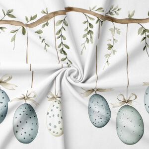 zbliżenie na detal tkaniny pokazujący akwarelowe jajka, wstążki i gałązki