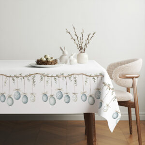 aranżacja świątecznego stołu z obrusem, gniazdo z przepiórczymi jajkami i dekoracyjnymi króliczkami