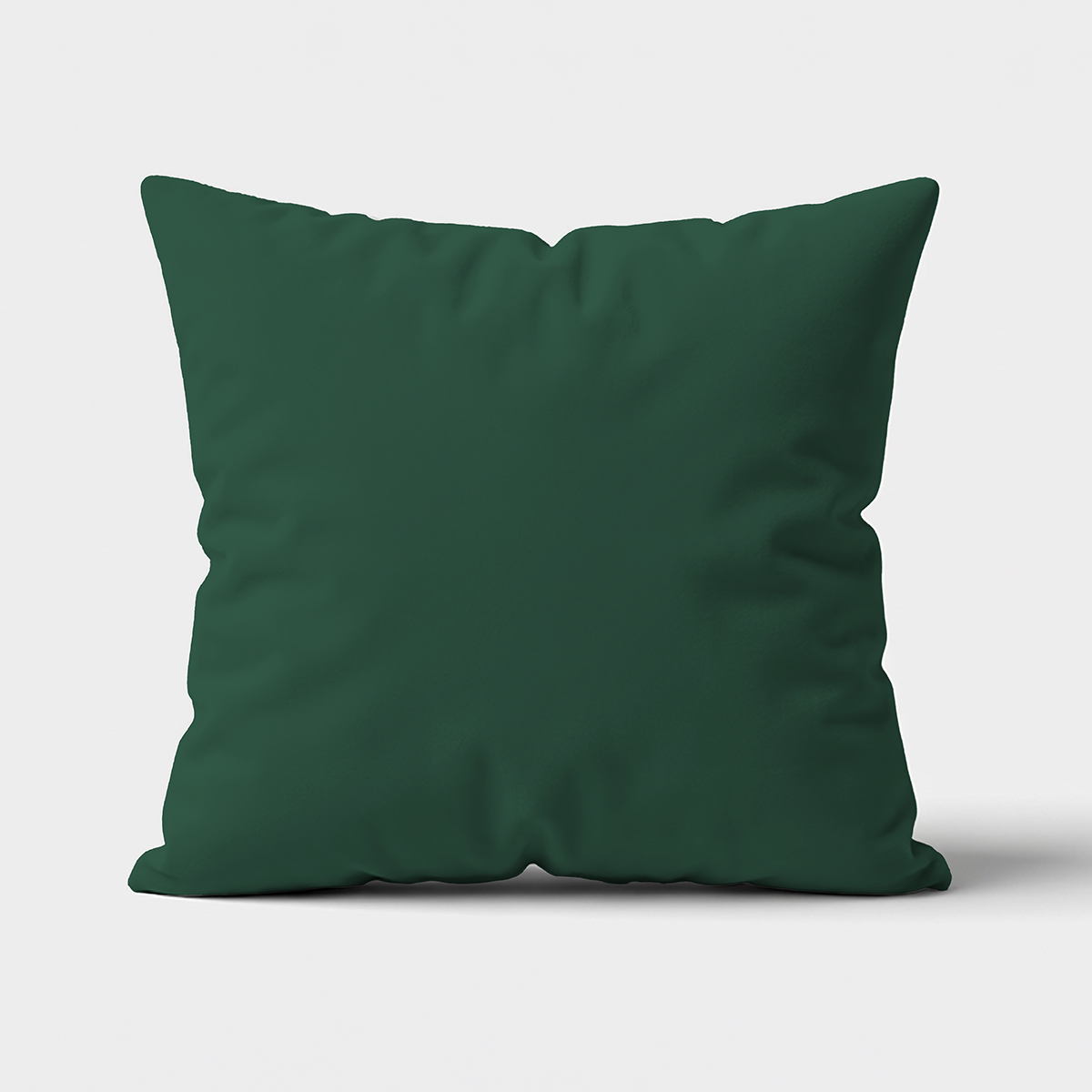 Główne ujęcie poduszki dekoracyjnej w butelkowej zieleni na jasnym tle